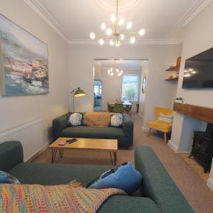 a living room with two couches and a table at Potts House - Hornsea on the Yorkshire coast in Hornsea