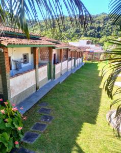 a view of a house with a yard at Chalés Luz Da Lua in Caraguatatuba