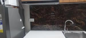 a kitchen with a sink and a granite wall at LBS Condo Rental-Full Relaxing Seaview 304-10Flr in Lapu Lapu City +11 photos