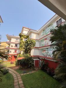 a large building with plants on the side of it at River side apartment in Cavelossim