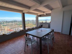 a dining room with a table and chairs and a balcony at Vecchio Calzaturificio Verducci Affittacamere in Montegranaro