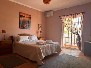 a bedroom with a bed and a large window at Villa Mar in Albufeira +20 photos