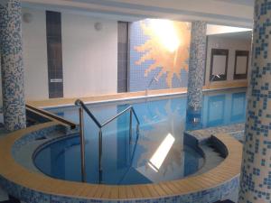 a swimming pool with a hot tub in a building at Hotel Vila Anna in Trenčianske Teplice