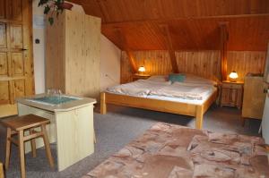 a bedroom with a bed and a table in a cabin at Privat U Milana Hlavná 316 in Ždiar +44 photos