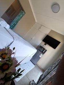 an overhead view of a kitchen with a vase of flowers at Peacefull Haven in Rustenburg +19 photos
