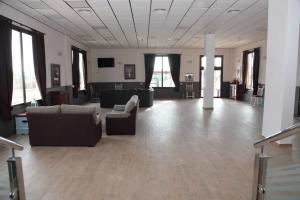 a large room with couches and chairs in a building at Hotel Lorenzo in El Contador