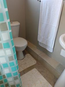 a bathroom with a toilet and a sink at Peacefull Haven in Rustenburg