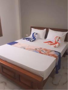 two beds in a room with dolls on them at Ananyah Villa in Trincomalee