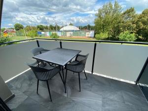 a table and two chairs on a balcony at Luxury Apartments Keszthely in Keszthely