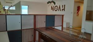 a room with a wooden counter with glass doors at Noah Housing in Santo Tomé