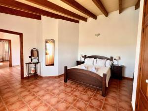 a bedroom with a bed and a tile floor at Villa Natural Barcarés in Alcudia