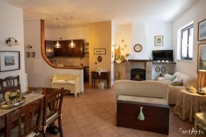 a living room with a couch and a table at SantAntò nel cuore di Trivigno 120 mt in Trivigno