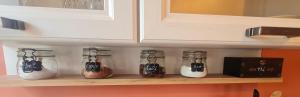 a shelf with jars of food and a box on it at Maison campagne détente in Thorigné-sur-Dué