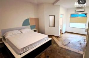 1 dormitorio con 1 cama blanca grande en una habitación en Noah Housing en Santo Tomé