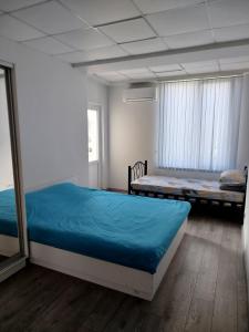 a bedroom with two beds and a mirror at Aydeniz hostel in Chişinău