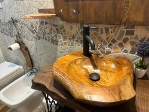 a wooden sink in a bathroom with a sink at Dimora Forgione B&B - Pietrelcina in Pietrelcina +116 photos
