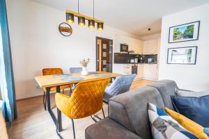 a living room with a table and a couch at MK Apartments - An der Vechte in Nordhorn