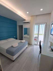 a bedroom with a bed and a blue wall at Dreams Tropea Mare "Parking Private" in Tropea