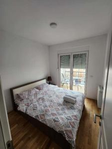 a bedroom with a bed with a quilt on it at Luxury & Green Apartments Modern Stay with Private Terrace in Pristina +28 photos