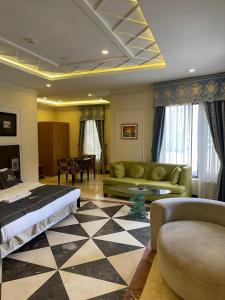 a living room with a bed and a couch at Hotel 5092 in Abuja