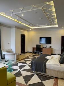 a room with a bed and a tv on the ceiling at Hotel 5092 in Abuja