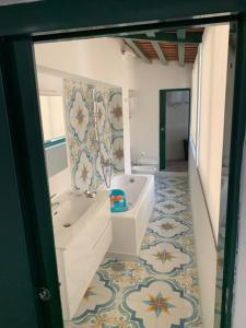 a bathroom with a tub and a sink in a room at Captain House Luxury House in Piazzetta in Capri +38 photos