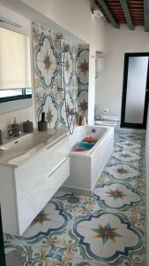 a bathroom with a sink and a mirror and a tub at Captain House Luxury House in Piazzetta in Capri