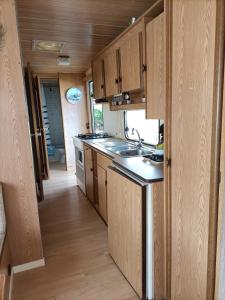 a kitchen with wooden cabinets and a sink at Mobil home inter in Berck-sur-Mer