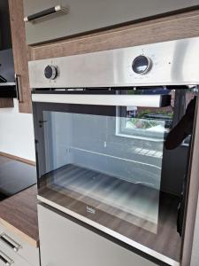 an oven with the door open in a kitchen at Pension Weserufer in Brake