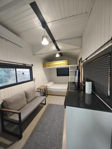 a kitchen and living room with a couch and a table at Tiny Mini House in Dalaman
