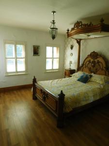 a bedroom with a large bed with a canopy at Willow Cottage Accommodation F91X0C8 in Sligo