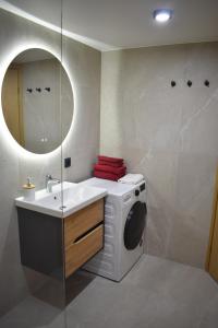 y baño con lavadora y lavamanos. en Suur-Posti Apartments en Pärnu