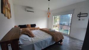 a bedroom with a bed with a blanket on it at Casa Quinta La Bachi in Arturo SeguÃ­