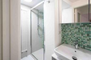 a bathroom with a glass shower and a sink at Appartamento Casa San Nicola in Putignano +12 photos