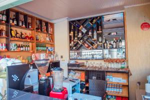 a bar with a lot of bottles on the shelves at Mountain View Hotel & Apartment in Kigali