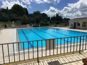 a large swimming pool with blue water at Hauts de st pierre belle terrasse Fayence in Fayence