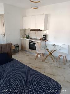 a kitchen with a table and a table and chairs at Zara's Boutique near Venizelos metro station in Thessaloniki +4 photos