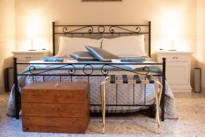 a bedroom with a black bed with two night stands at La Casa della Campana in Cortona