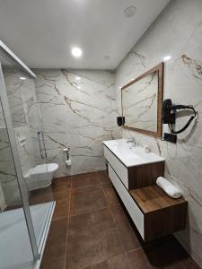 a bathroom with a sink and a shower at Apartamento Casa Cruceiro in Arzúa +16 photos