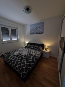 Postel nebo postele na pokoji v ubytování Apartmani Ždrijac Nin