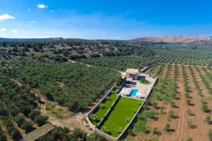 an aerial view of a house in a field at Nestor Villa, with Private Pool & Absolute Privacy in Roumelí