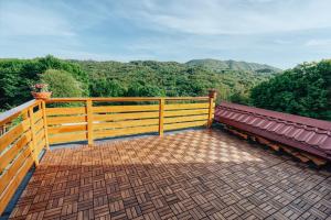 a bench on a balcony with a view of mountains at Apartment Pri Braceku - Odmor u prirodi - Nature Retreat & Relaxation in Samobor