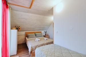 a bedroom with two beds in a room at Apartment Pri Braceku - Odmor u prirodi - Nature Retreat & Relaxation in Samobor
