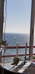 a view of the ocean with sailboats in the water at Apartamento Mar y Paz 15 in Calpe