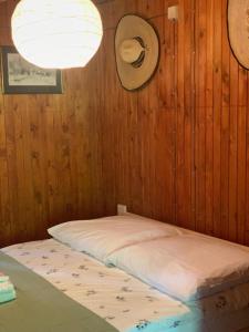 a bed in a room with a hat on the wall at Dom z linią brzegową Narwi 2 in Pultusk +27 photos