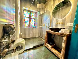 a bathroom with a sink and a stained glass window at Casa Albastră by Casa Otto in Sighişoara