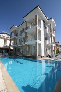 a large swimming pool in front of a building at Stella Classic Apartments in Fethiye