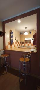 een keuken met 2 barkrukken en een aanrecht bij San Isidro EL LLAR 122 in San Isidro