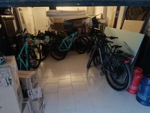 a group of bikes parked in a room with boxes at Suites & Apartments DP VFXira in Vila Franca de Xira