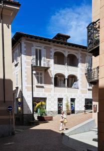 a little girl walking in front of a building at Appartamento La Torretta in Locarno